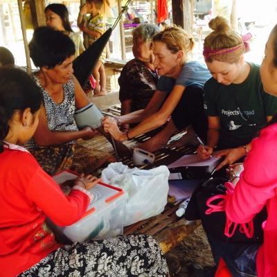 During a Projects Abroad outreach on the Public Health Internship for teenagers in Cambodia, students assist local staff. Interns learn how to take people’s blood pressure readings as part of Public Health work for teenagers in Cambodia.